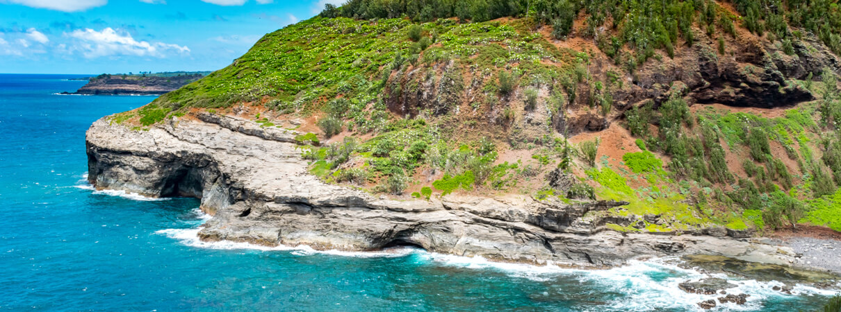 Hawaii is committed to achieving 100 percent of its energy from renewable sources by 2045, a goal that may spur the development of additional wind turbines on the islands. The state has also made some areas totally off limits to wind development, including the entire island of Kauai, pictured here. Photo by Milan van Weelden / Shutterstock